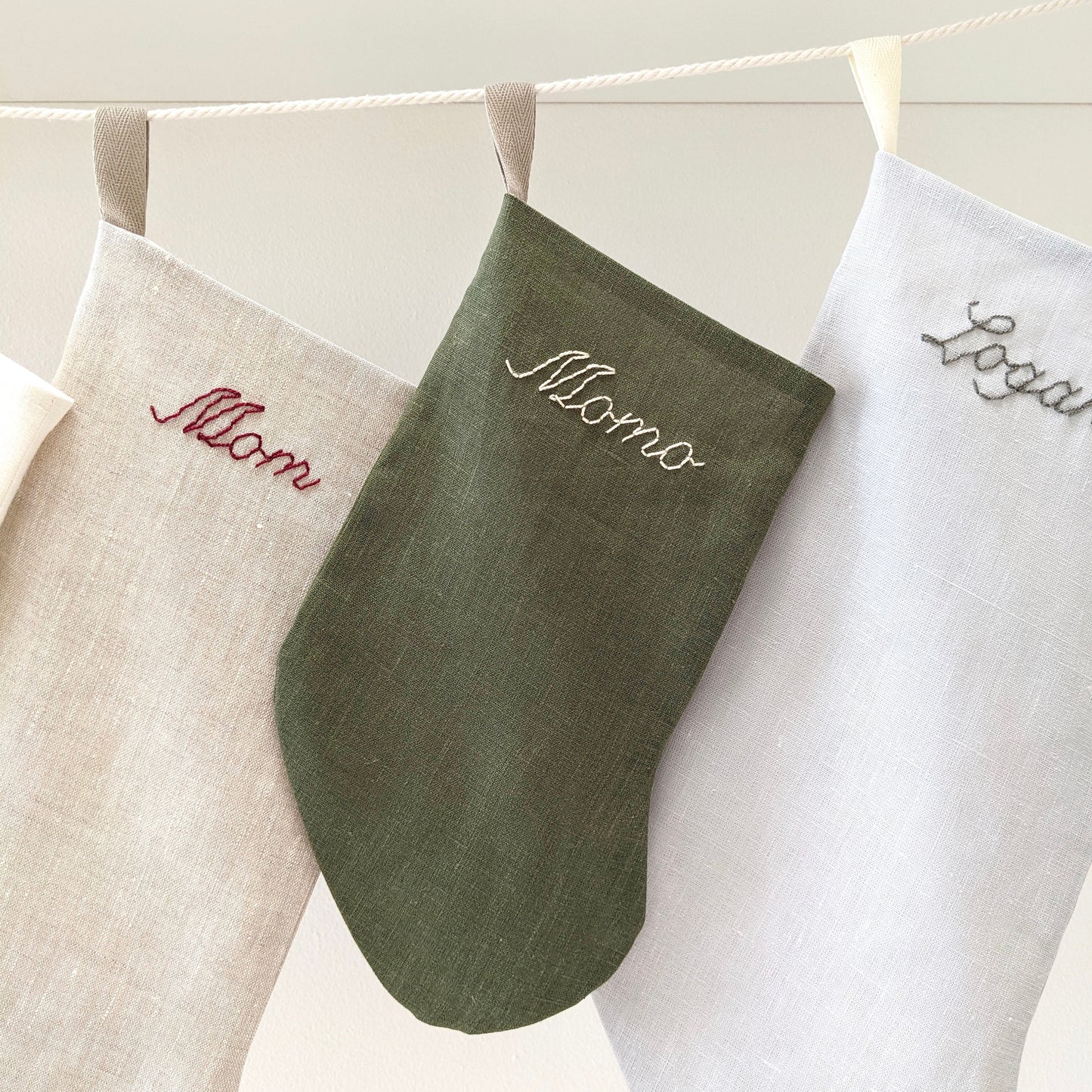 Simple classic hand embroidered green linen Christmas stocking with personalized name