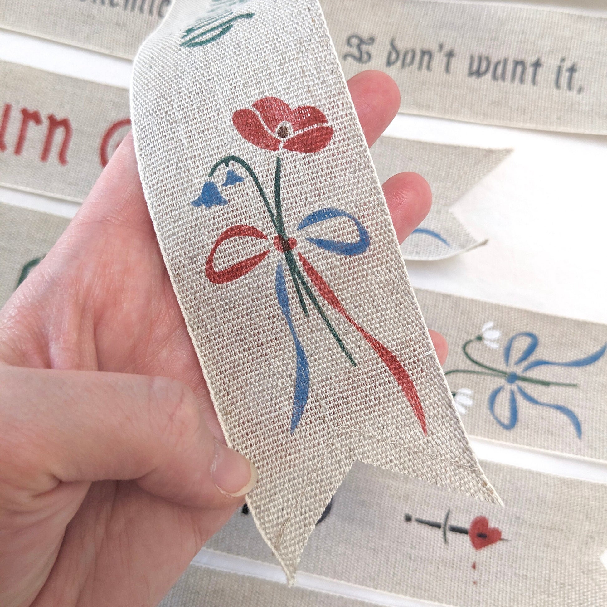 Hand painted bookmark with bluebells and poppies that reads "Enemies to Lovers Club"