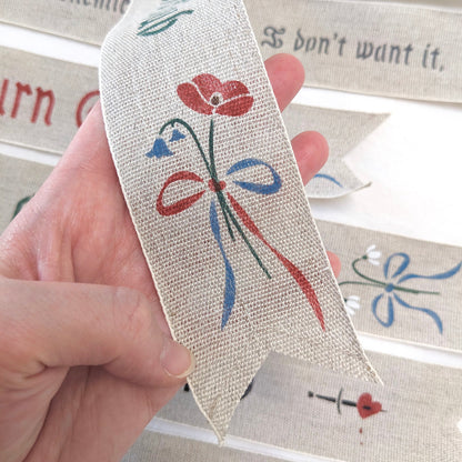 Hand painted bookmark with bluebells and poppies that reads "Enemies to Lovers Club"