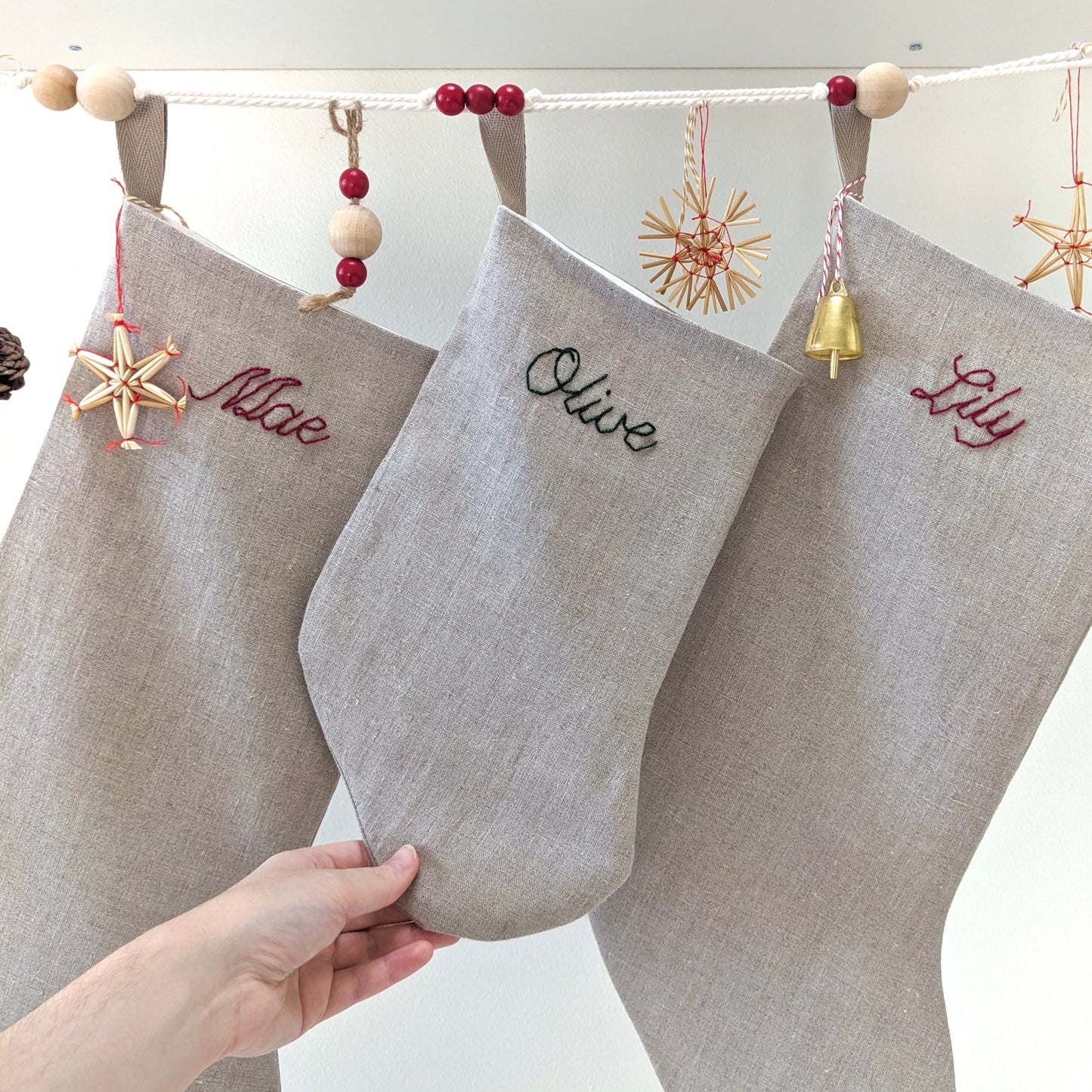 Hand embroidered natural linen Christmas stocking with name in red or green embroidery