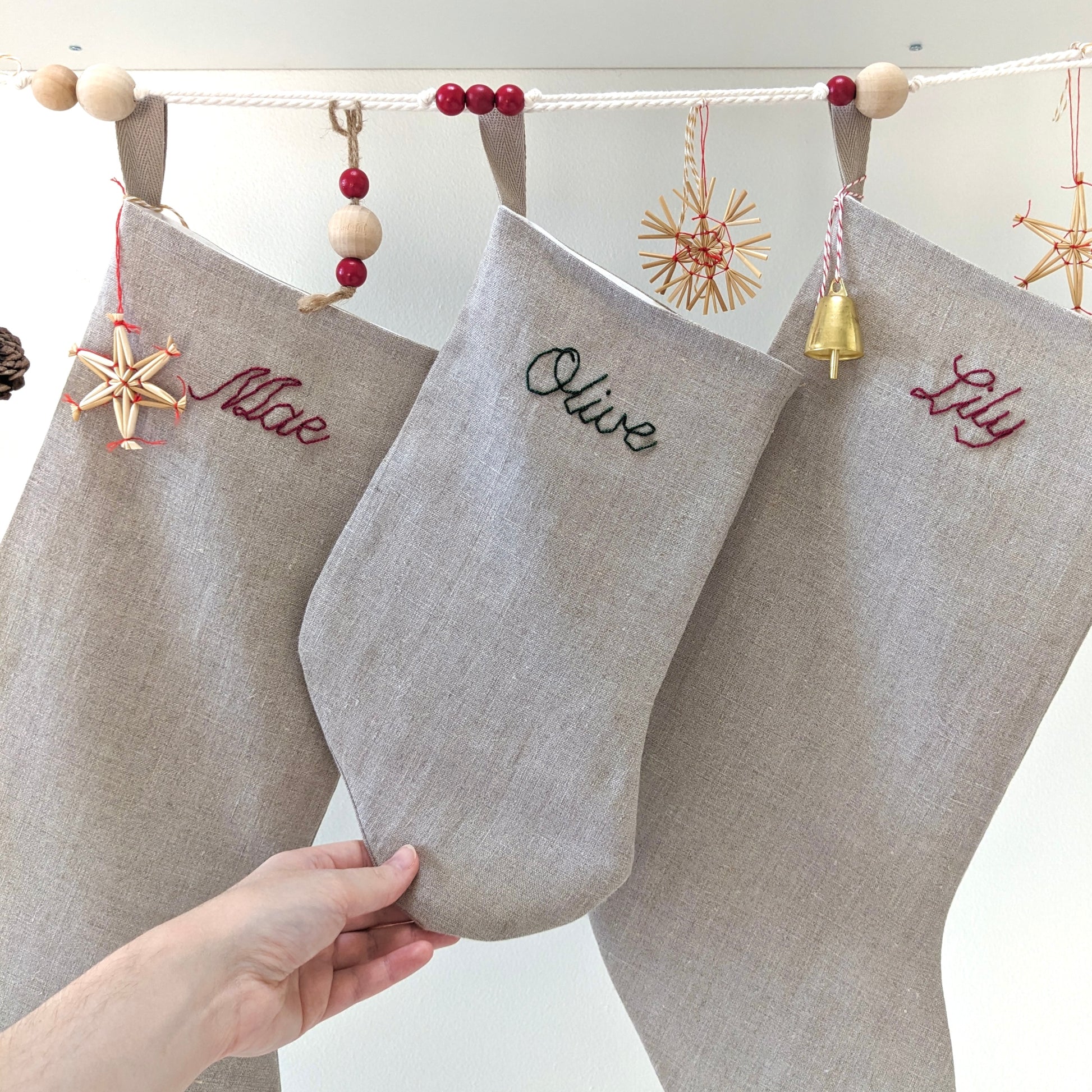 Hand embroidered natural linen Christmas stocking with name in red or green embroidery
