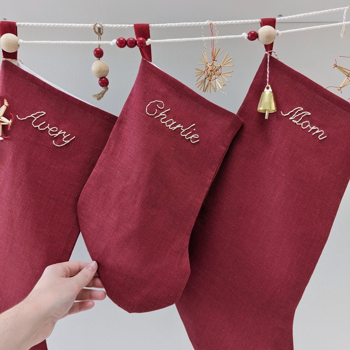 Hand embroidered red linen Christmas stocking with personalized name
