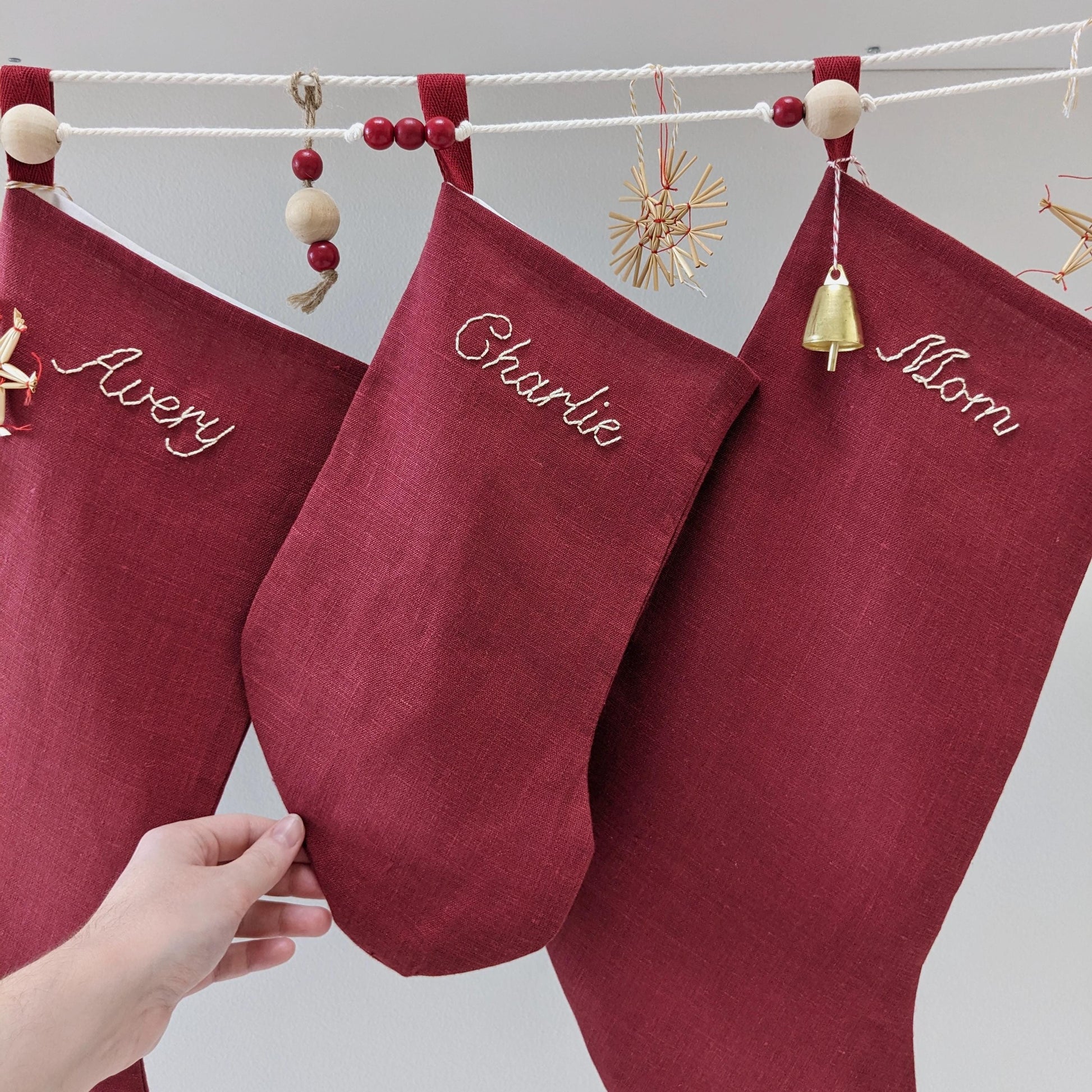 Hand embroidered red linen Christmas stocking with personalized name