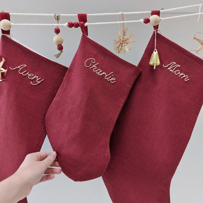 Hand embroidered red linen Christmas stocking with personalized name