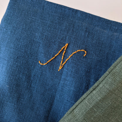 Hand embroidered linen Christmas stocking with personalized initial, blue with gold embroidery