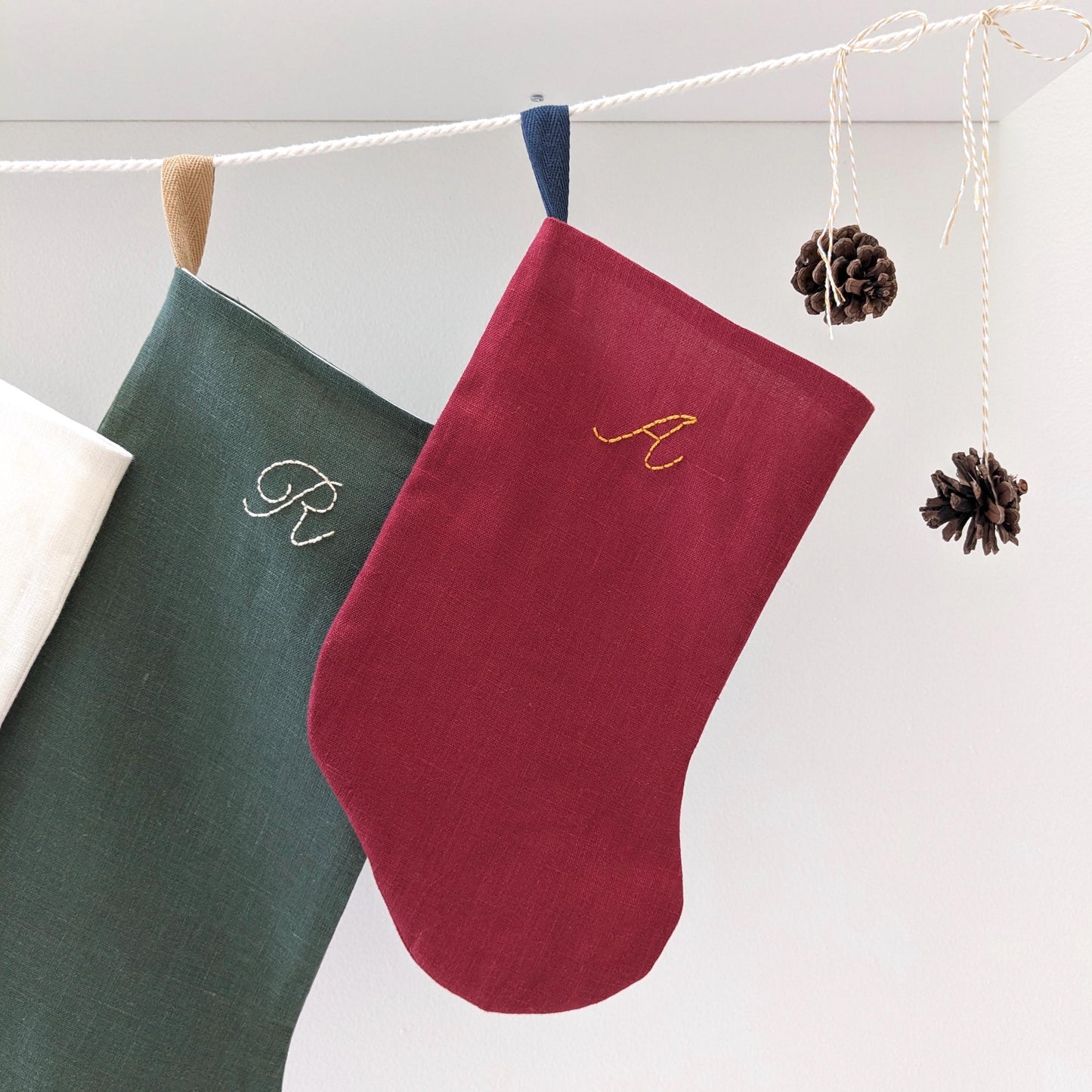Small hand embroidered linen Christmas stocking with personalized initial, red with gold embroidery