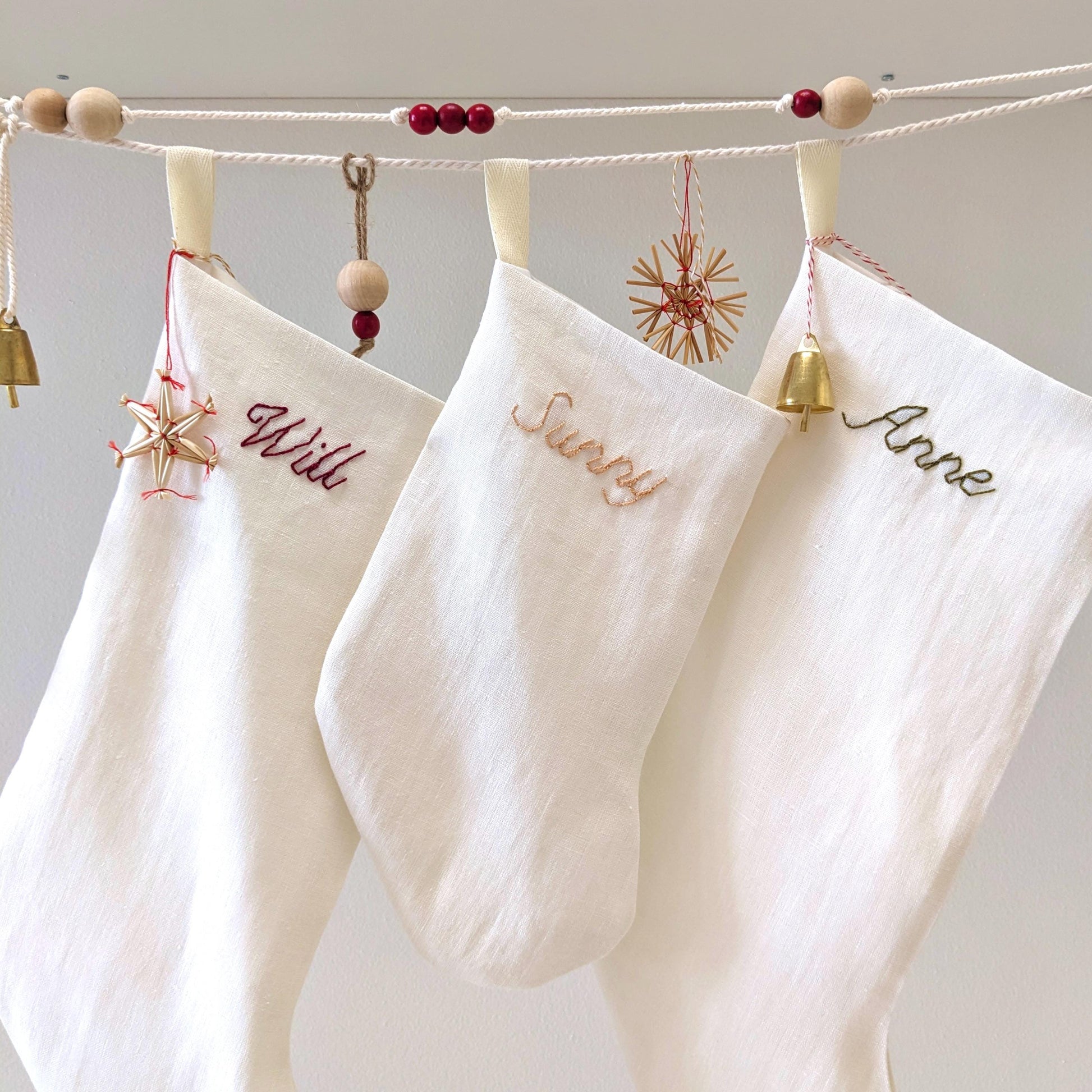 Hand embroidered ivory white linen Christmas stocking with personalized name
