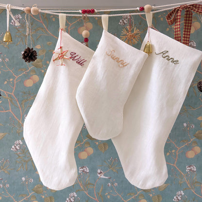 Hand embroidered ivory linen Christmas stocking with custom name