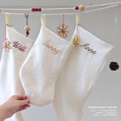 Hand embroidered white linen Christmas stocking with name