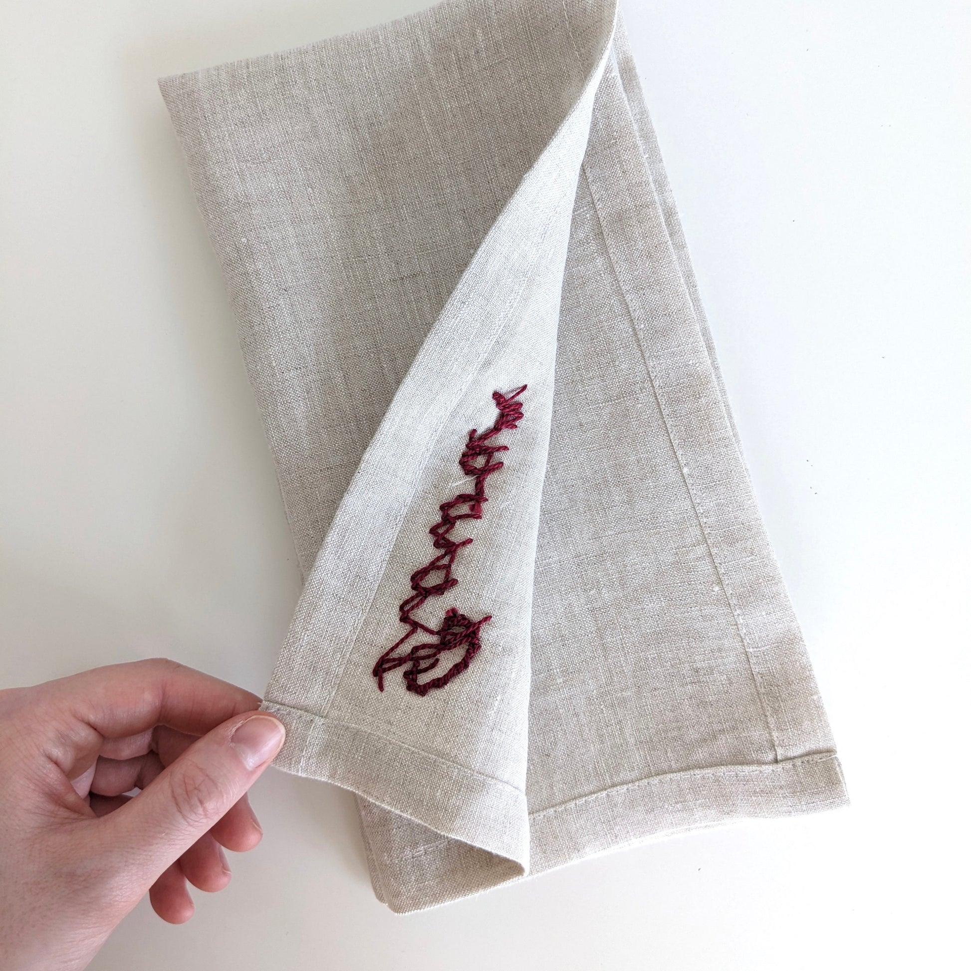 Hand embroidered linen napkin with custom name