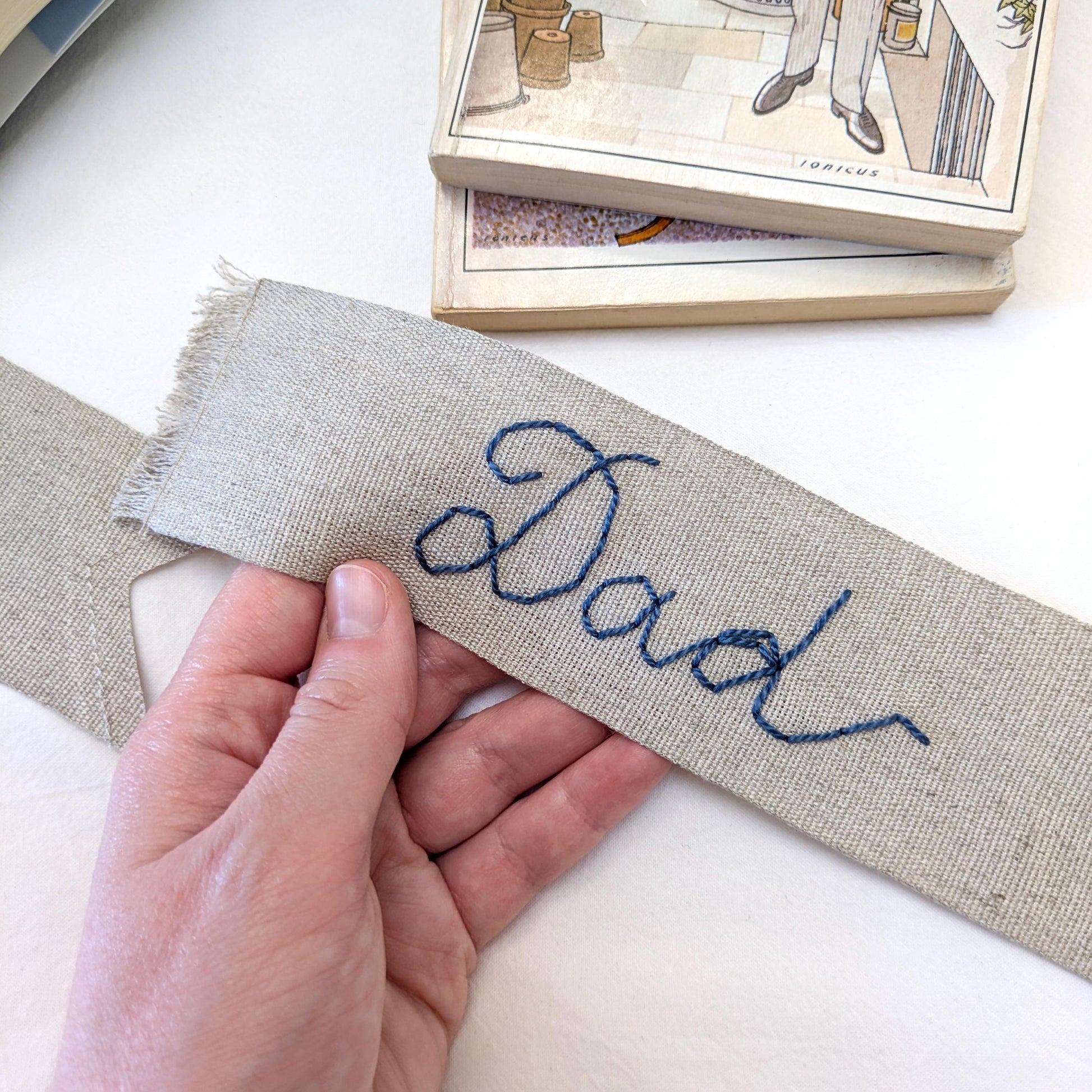 Hand embroidered linen ribbon bookmark that says Dad in your handwriting
