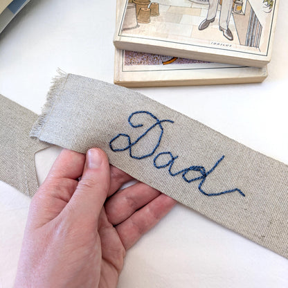 Hand embroidered linen ribbon bookmark that says Dad in your handwriting