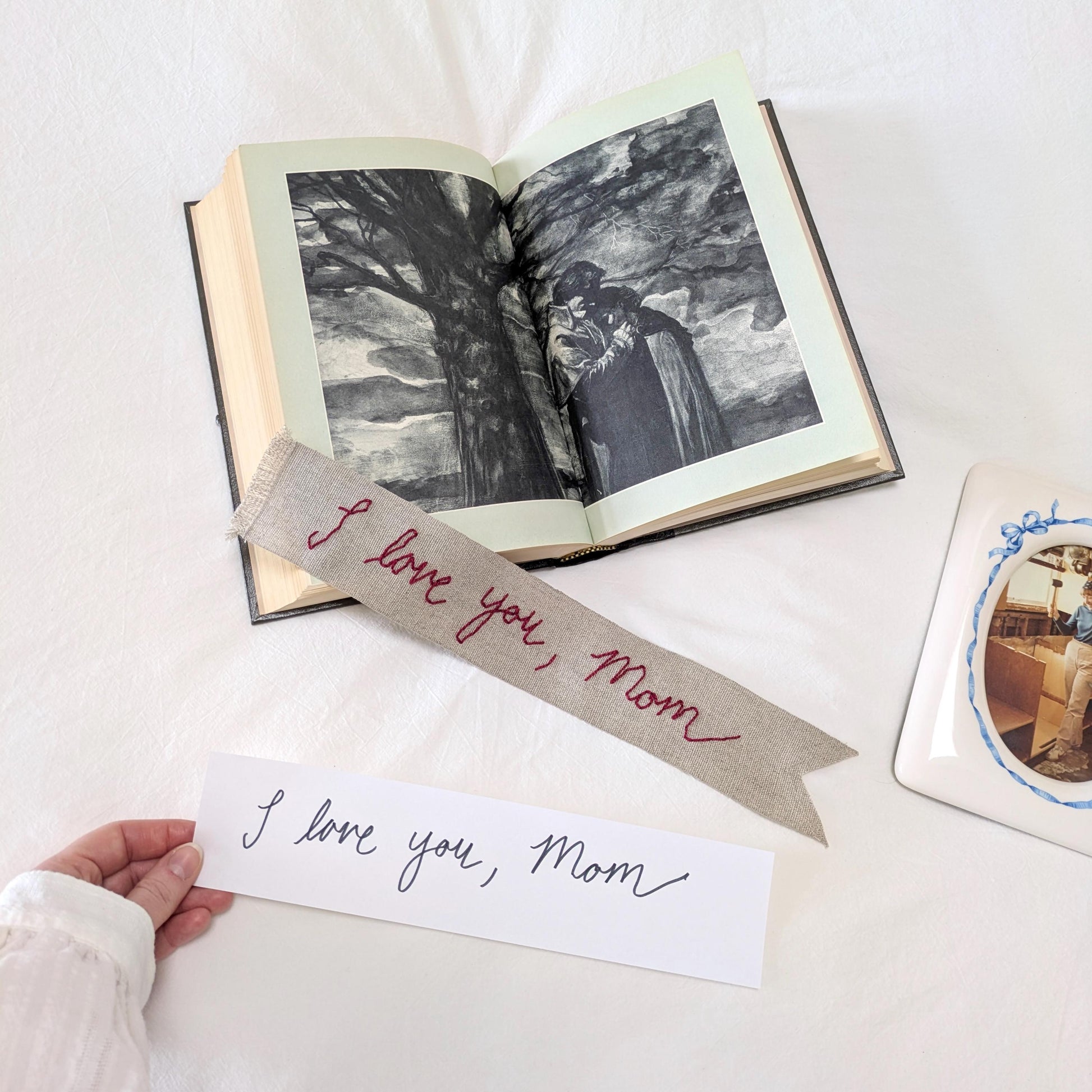 Hand embroidered linen ribbon bookmark that says "I love you, Mom" in your handwriting