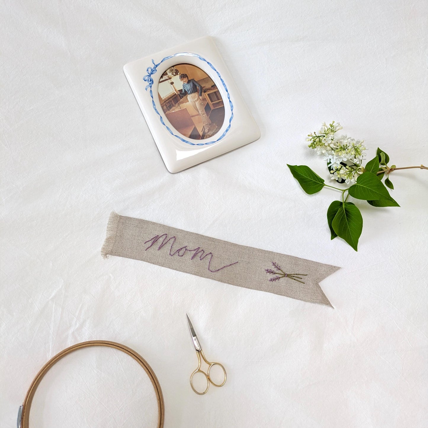 Hand embroidered linen ribbon bookmark that says Mom with a lavender motif