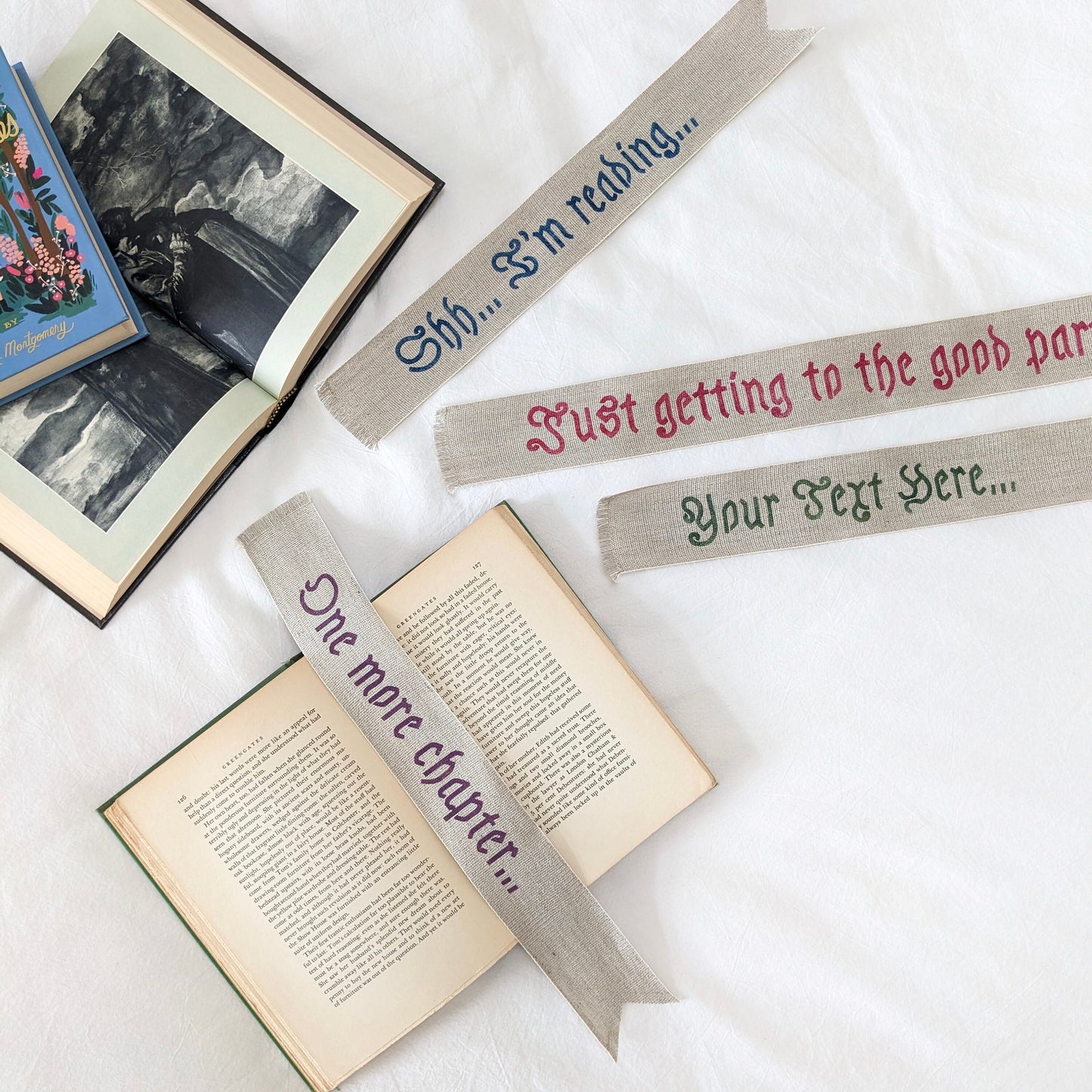 A hand painted linen ribbon bookmark that reads "Shh... I'm reading..." "Just getting to the good part..." or "One more chapter..."