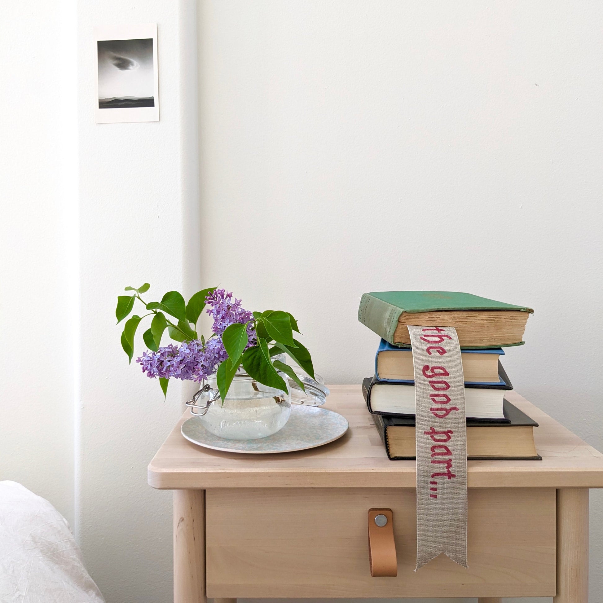 A hand painted linen ribbon bookmark that reads "Just getting to the good part..."
