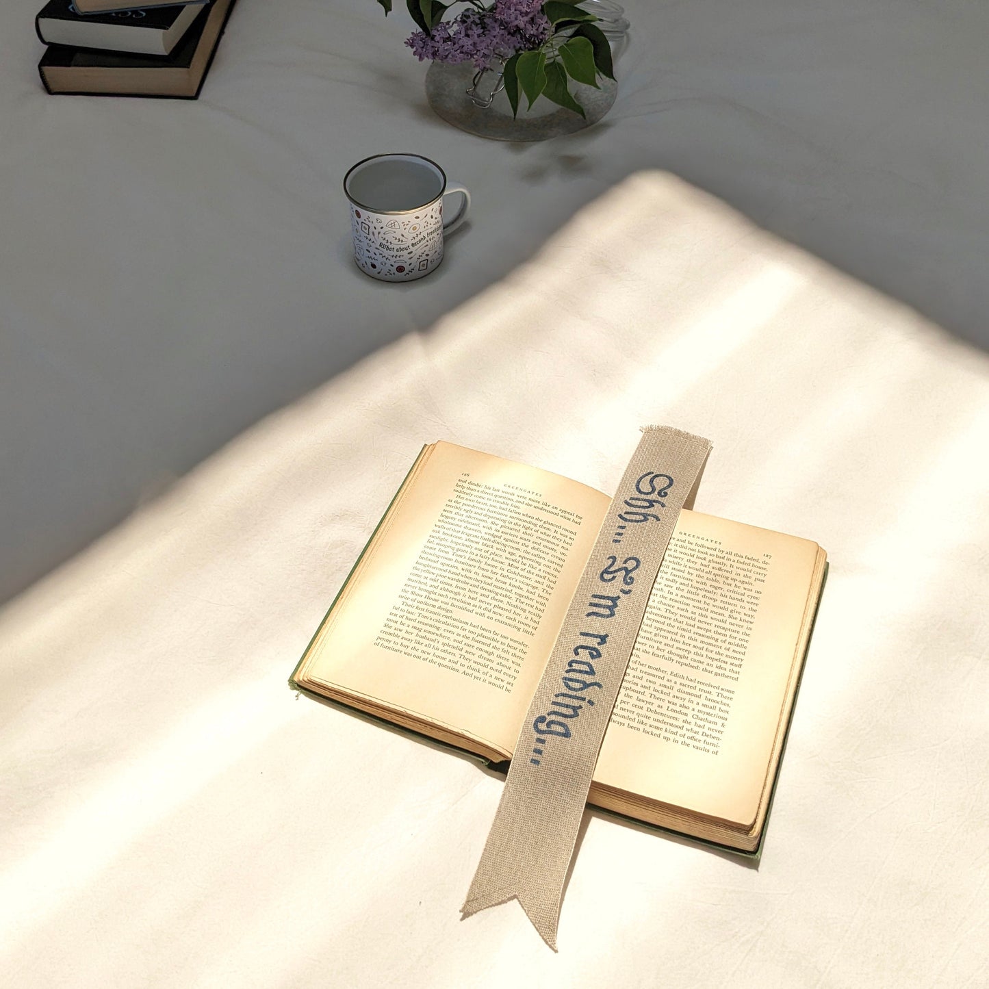 A hand painted linen ribbon bookmark that reads "Shh... I'm reading..."