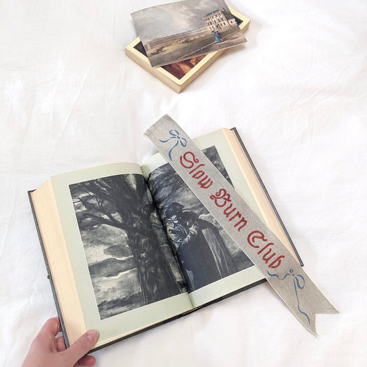 Hand painted linen ribbon bookmark that reads "Slow Burn Club"